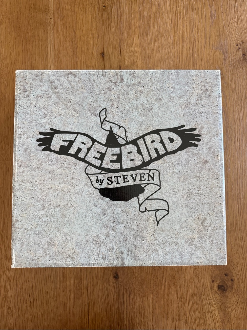 Freebird by Steven Neutral Stone Texture Bird Logo Box - Black Print